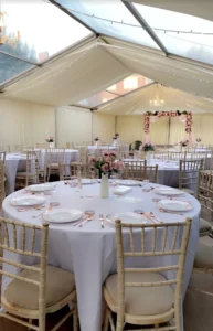 Wedding Marquee set out in a white and pink theme with pink roses.