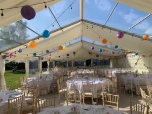 Wedding Marquee with mult-coloured lanterns on the ceiling.