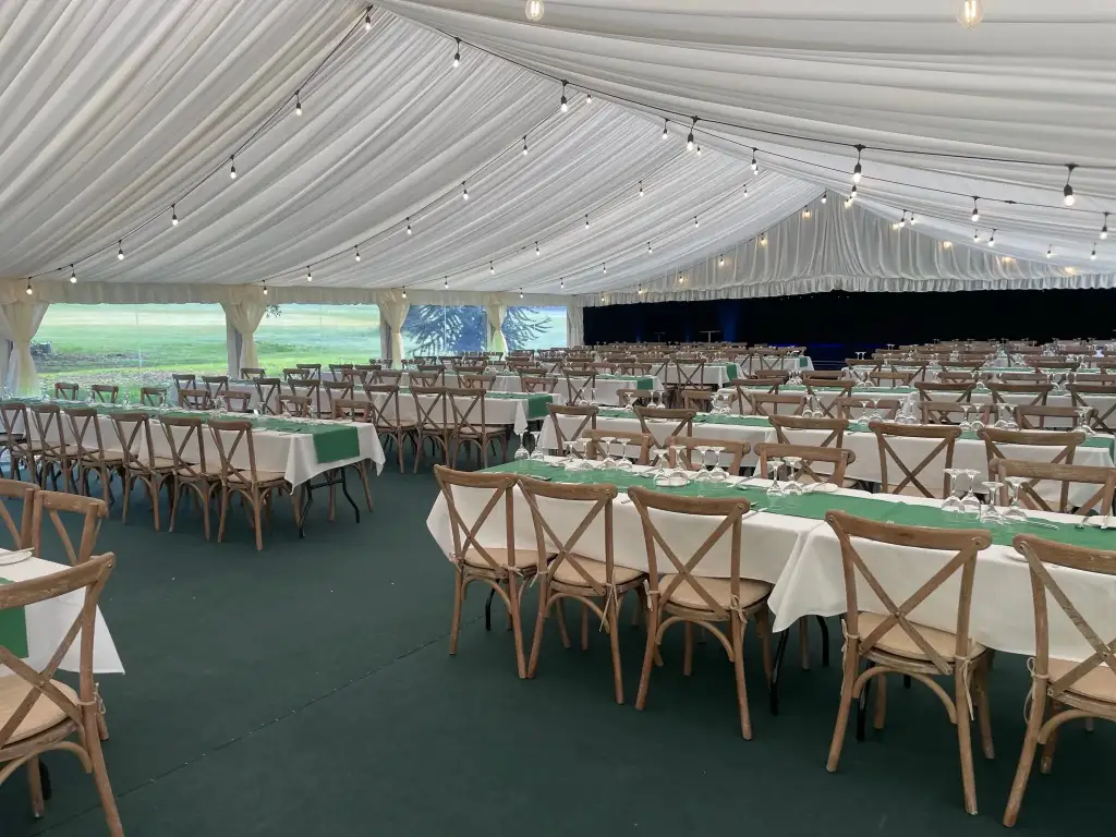 Interior of wedding marquee set up in banqueting style.