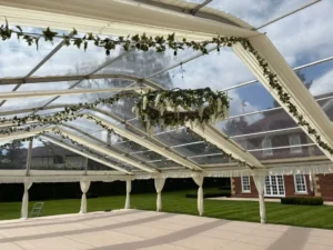 Luxury marquee interior with white flowers decorating the interior ceiling