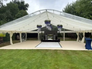 Open luxury marquee set up in large garden for party