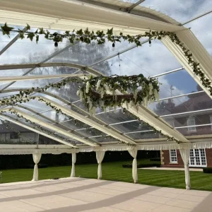 Luxury marquee interior with white flowers decorating the interior ceiling