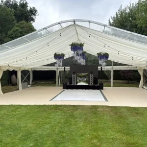 Open luxury marquee set up in large garden for party